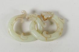 A Chinese carved celadon jade link puzzle, in the form of dragons. 1½" diameter