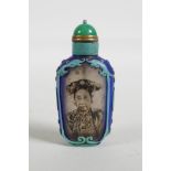 A Chinese reverse decorated glass snuff bottle depicting a Chinese lady and bamboo, 3" high