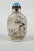 A Chinese reverse decorated glass snuff bottle, decorated with a musician & student in a