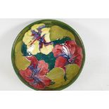 A Moorcroft pottery bowl decorated with hibiscus flowers, 6" diameter