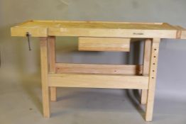 A Whitegate beechwood carpenter's  workbench, with pull out drawer and two vices, 55" x 22" x 34"