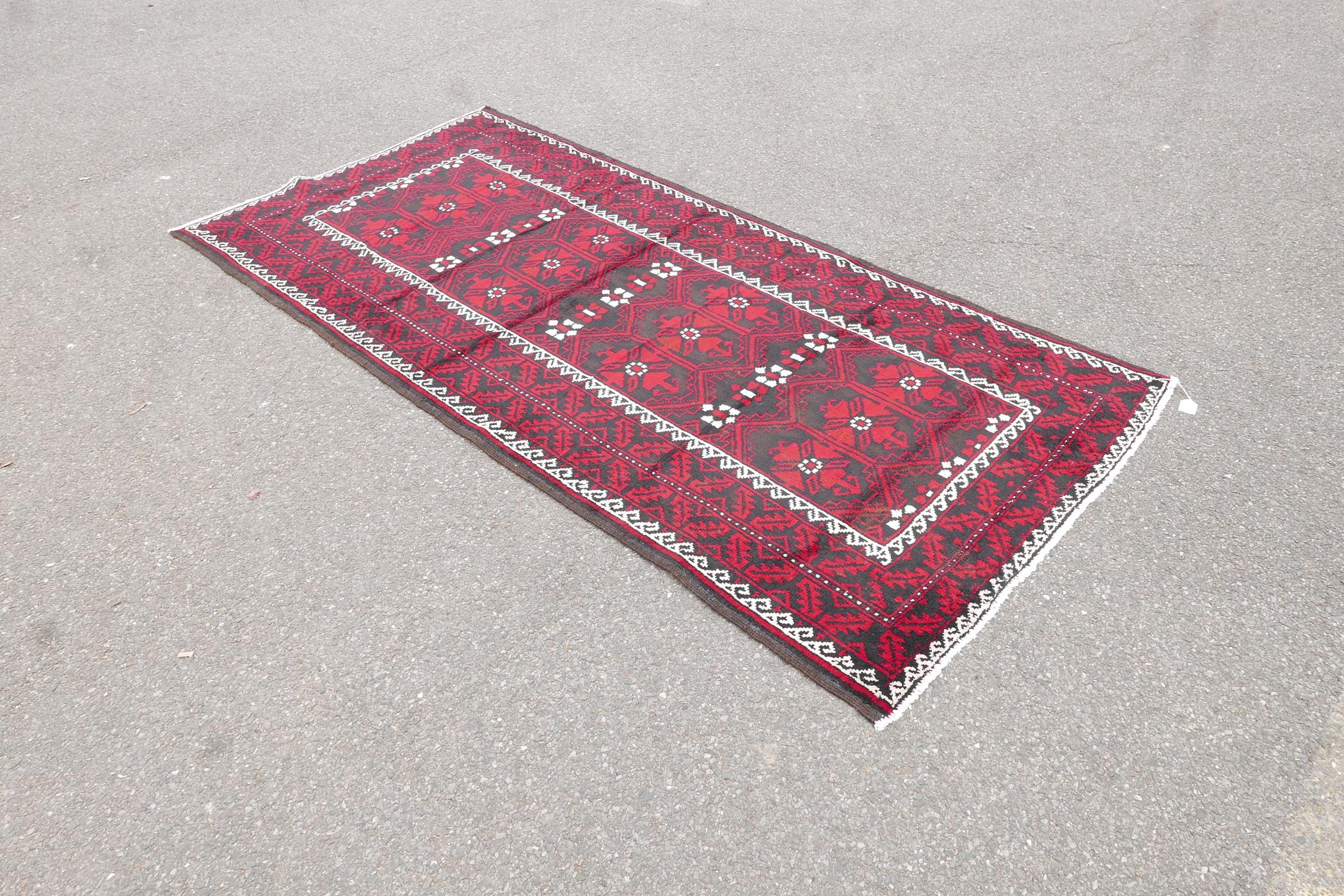 Hand woven full pile red and black ground Iranian Belouch rug, 50½" x 110" - Image 2 of 5