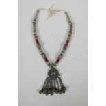 A Turkmen white metal & bead necklace with an Ottoman coin feature pendant, set with stones & bells,