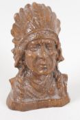 A carved hardwood bust of an American first Nation man, in chieftains head dress, 4½" high
