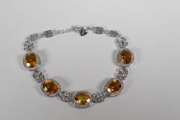 A 925 silver, cubic zirconia and citrine set bracelet, 7" long