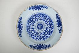 An C18th/C19th Delft blue and white charger decorated with a hand painted floral pattern, A/F,