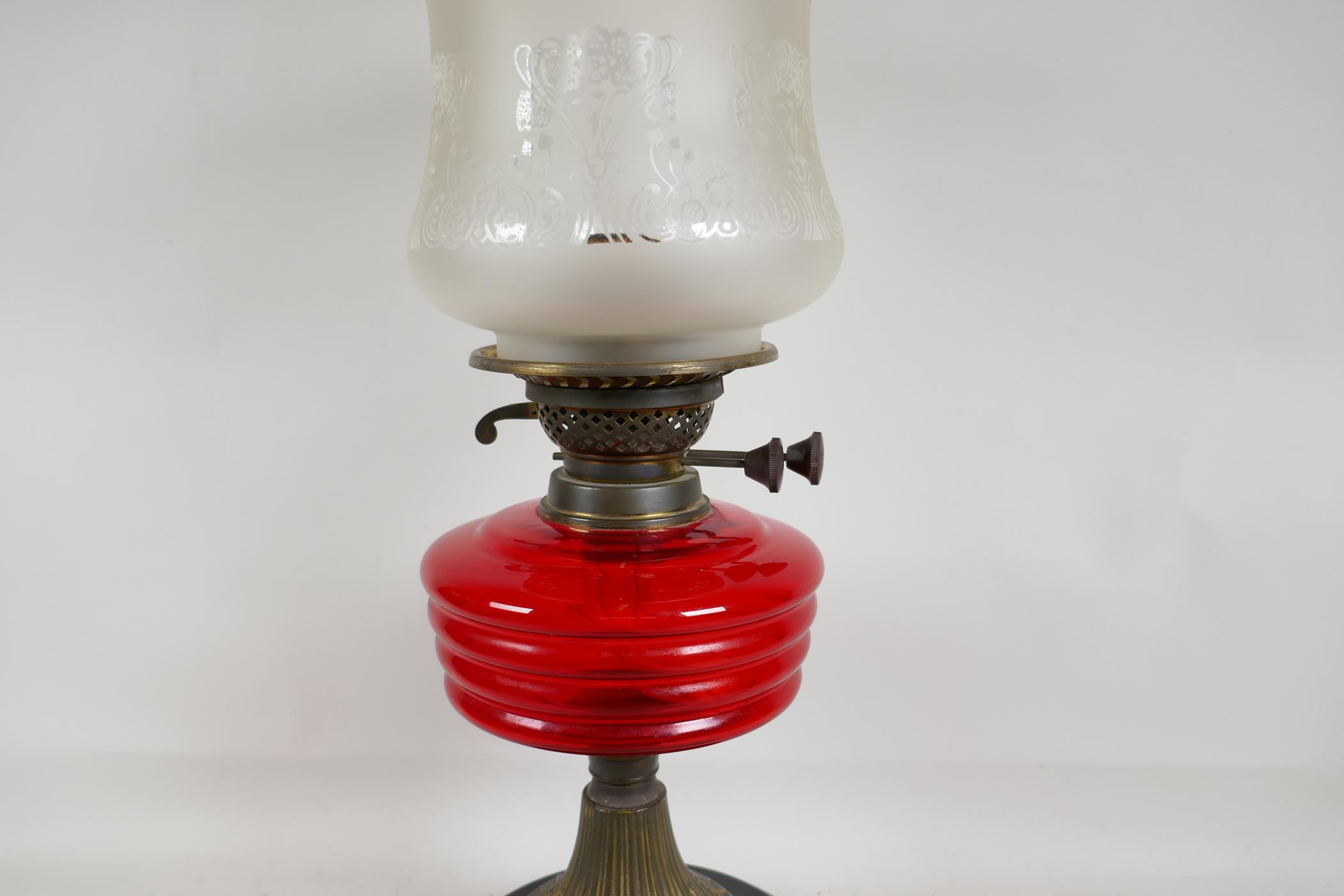 A C19th brass and glass oil lamp with cranberry glass shade, 21" high - Image 2 of 4