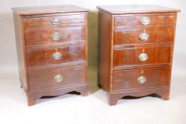 A pair of mahogany chests of four long drawers, with brass 'Trafalgar' plate handles, raised on