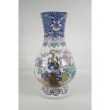 A Chinese famille rose enamelled porcelain vase, decorated with peacocks amongst flowers, 6
