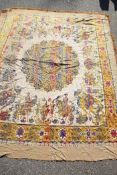 A large Indian silk woven bedspread, decorated with processional and tiger hunting scenes, around