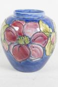 A Moorcroft pottery bulbous vase decorated with large flowers, signed, 7" high