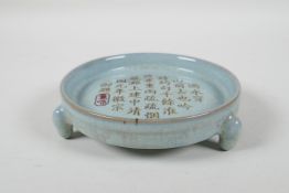 A Chinese Ru-Ware style blue glazed dish on tripod supports, with chased & gilt character