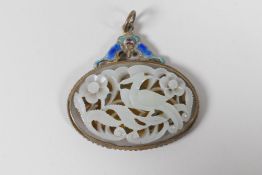 A Chinese carved white jade pendant depicting a phoenix, set in an enamelled silver gilt mount,