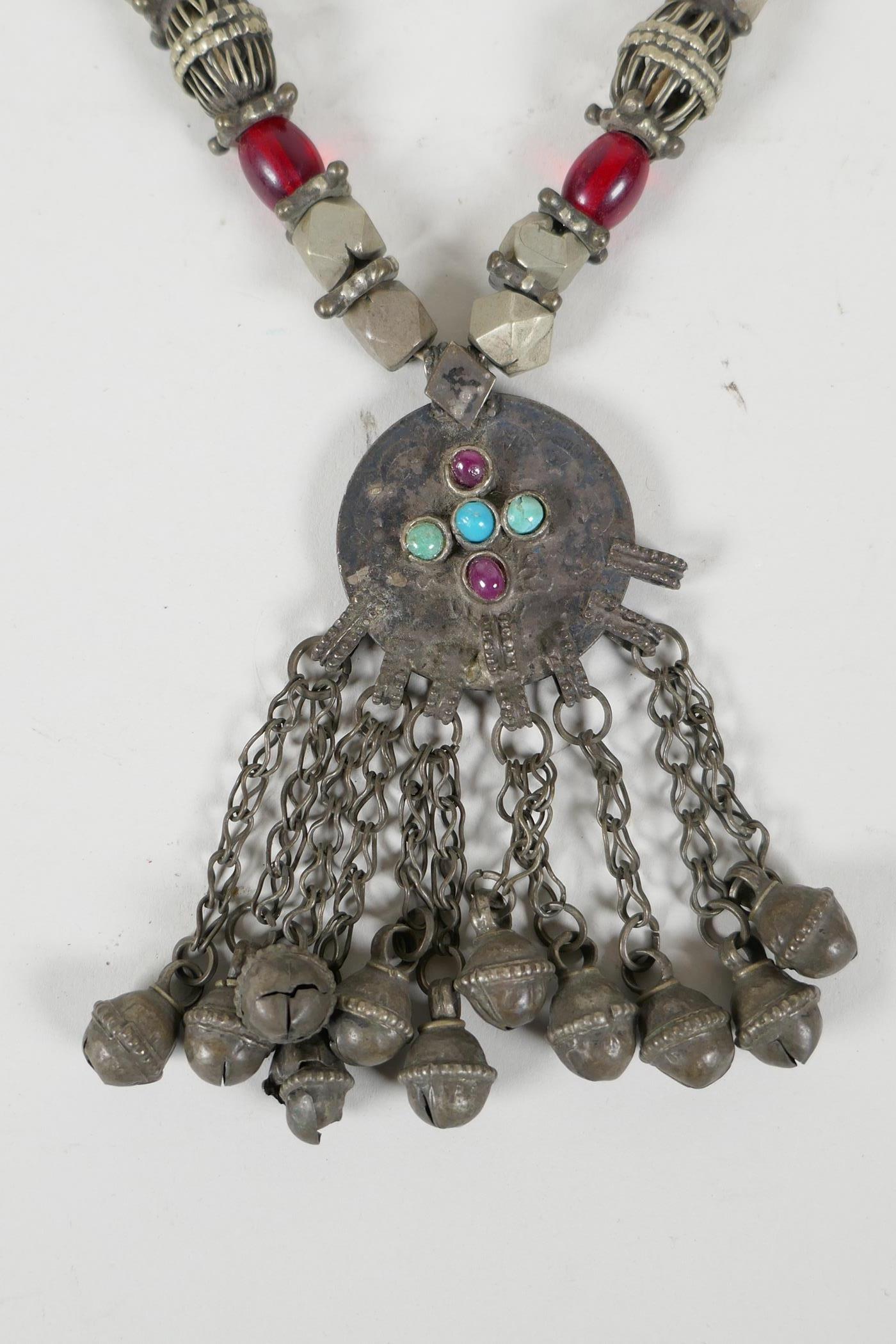 A Turkmen white metal & bead necklace with an Ottoman coin feature pendant, set with stones & bells, - Image 2 of 4
