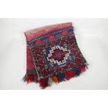 A Persian red & blue ground wool saddle bag, 35" x 16½"