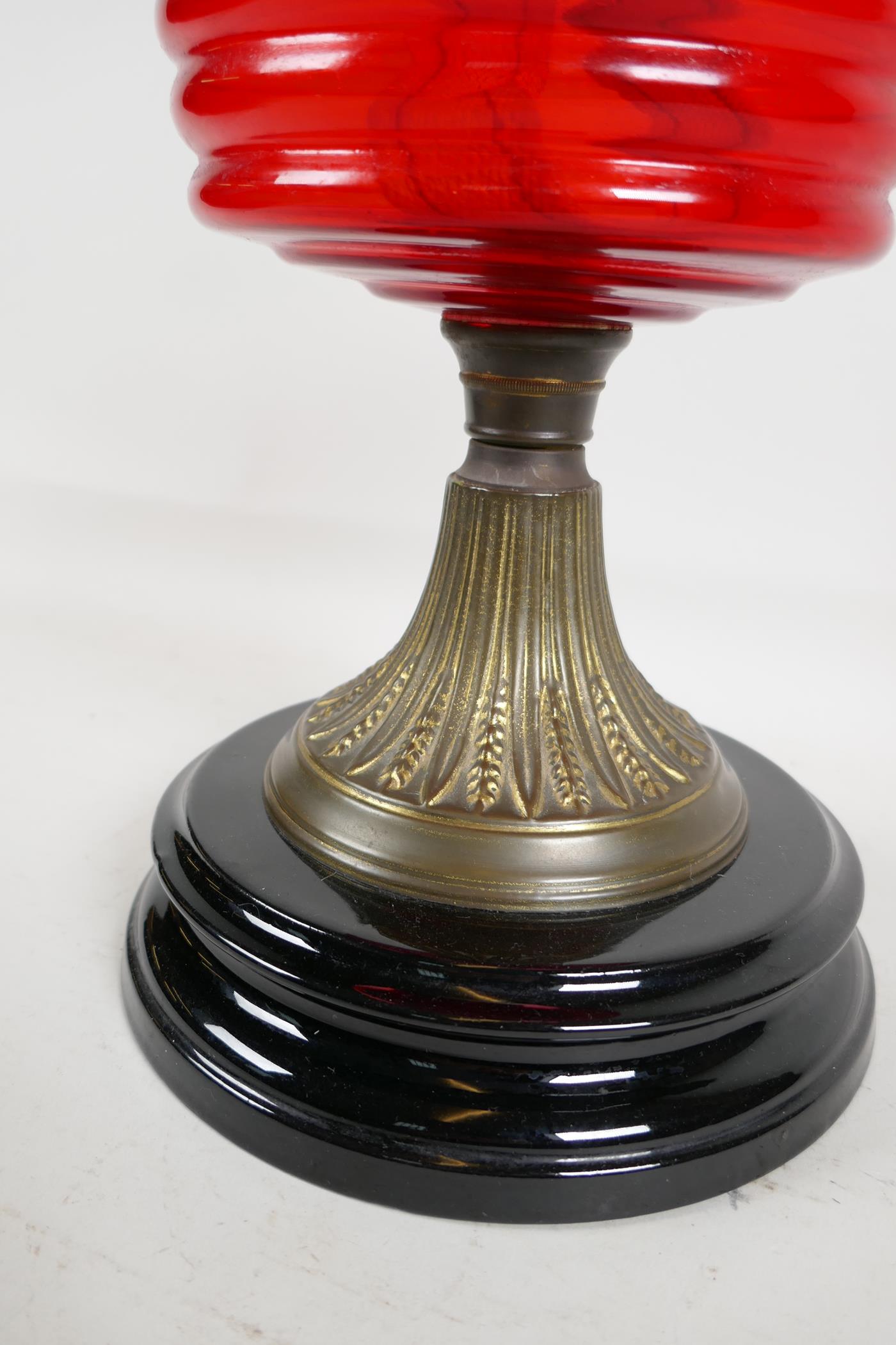 A C19th brass and glass oil lamp with cranberry glass shade, 21" high - Image 4 of 4