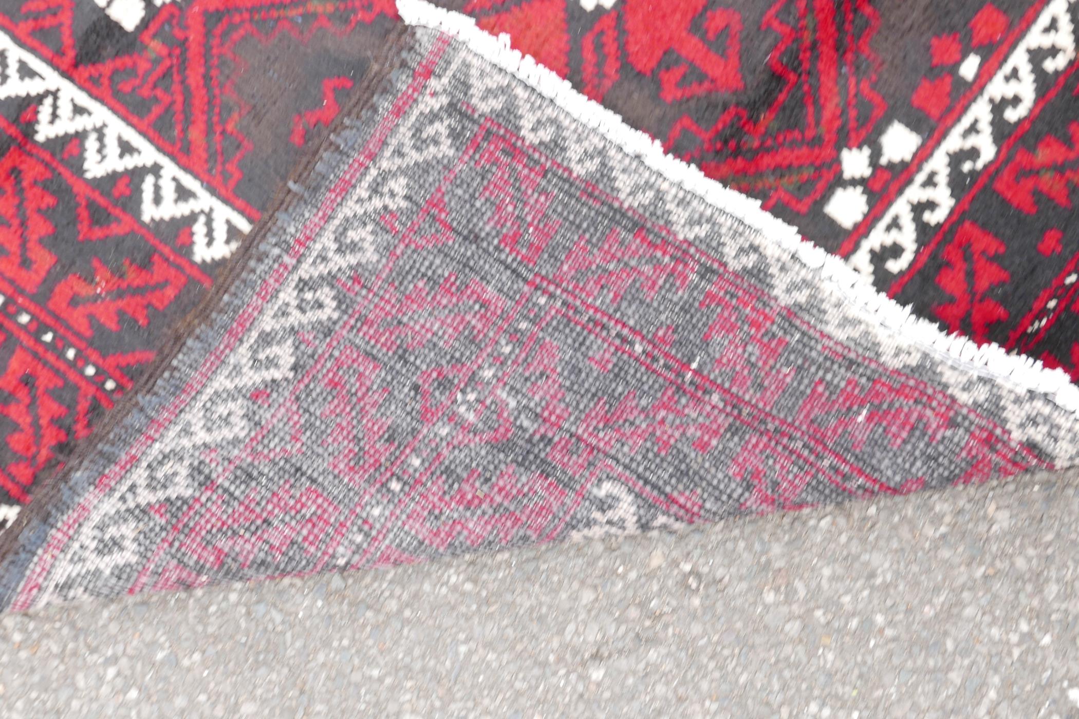 Hand woven full pile red and black ground Iranian Belouch rug, 50½" x 110" - Image 5 of 5
