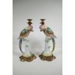 A pair of polychrome porcelain and gilt metal parakeet candlesticks, 16" high