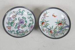 A pair of Chinese porcelain bowls painted with fruit flowers and bats, encassed in pewter frames. 6"