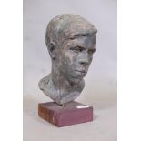 A painted plaster bust, head of a young man, on wood plinth, 13" high
