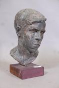 A painted plaster bust, head of a young man, on wood plinth, 13" high