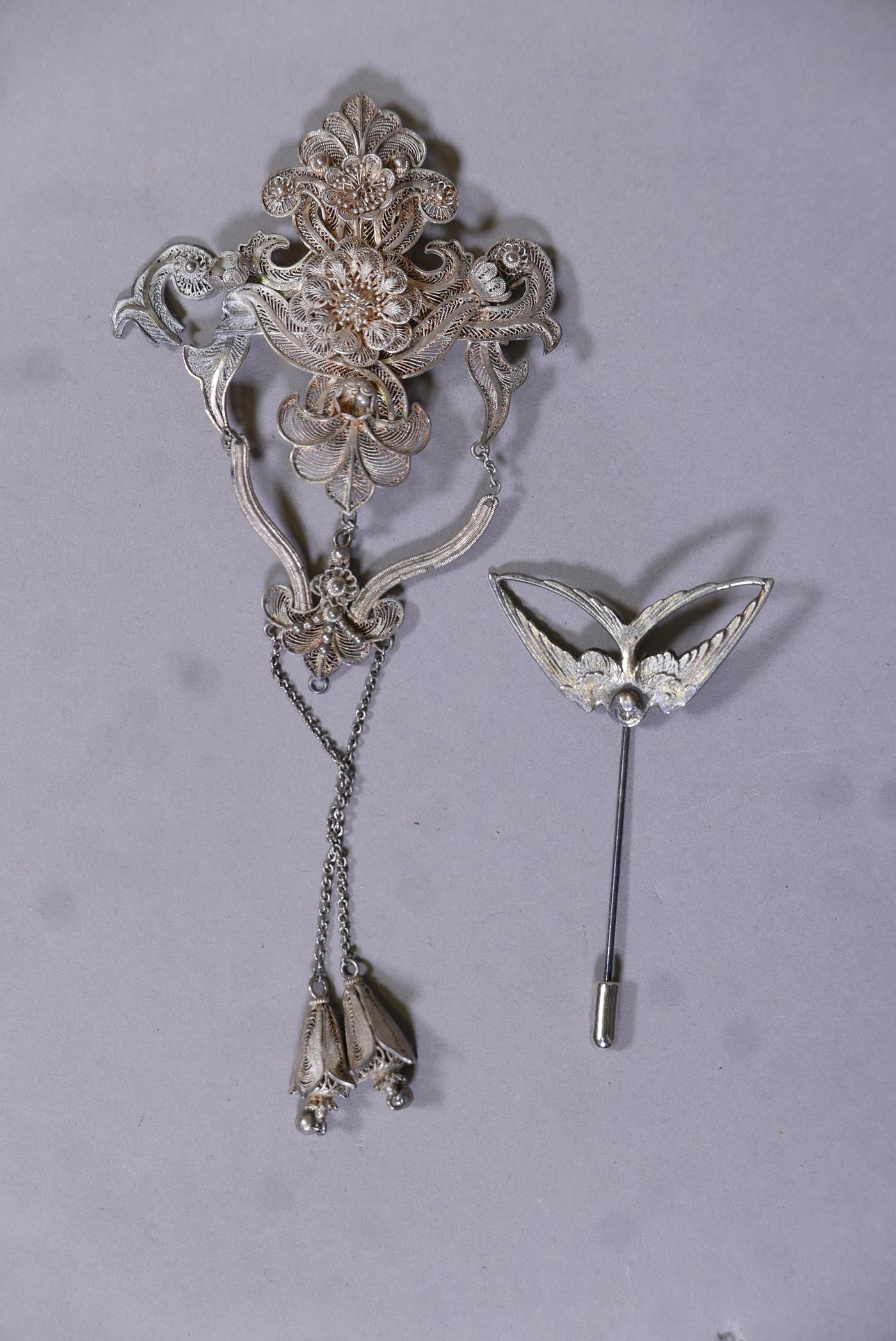 A vintage white metal filigree brooch, A/F, and a hat pin