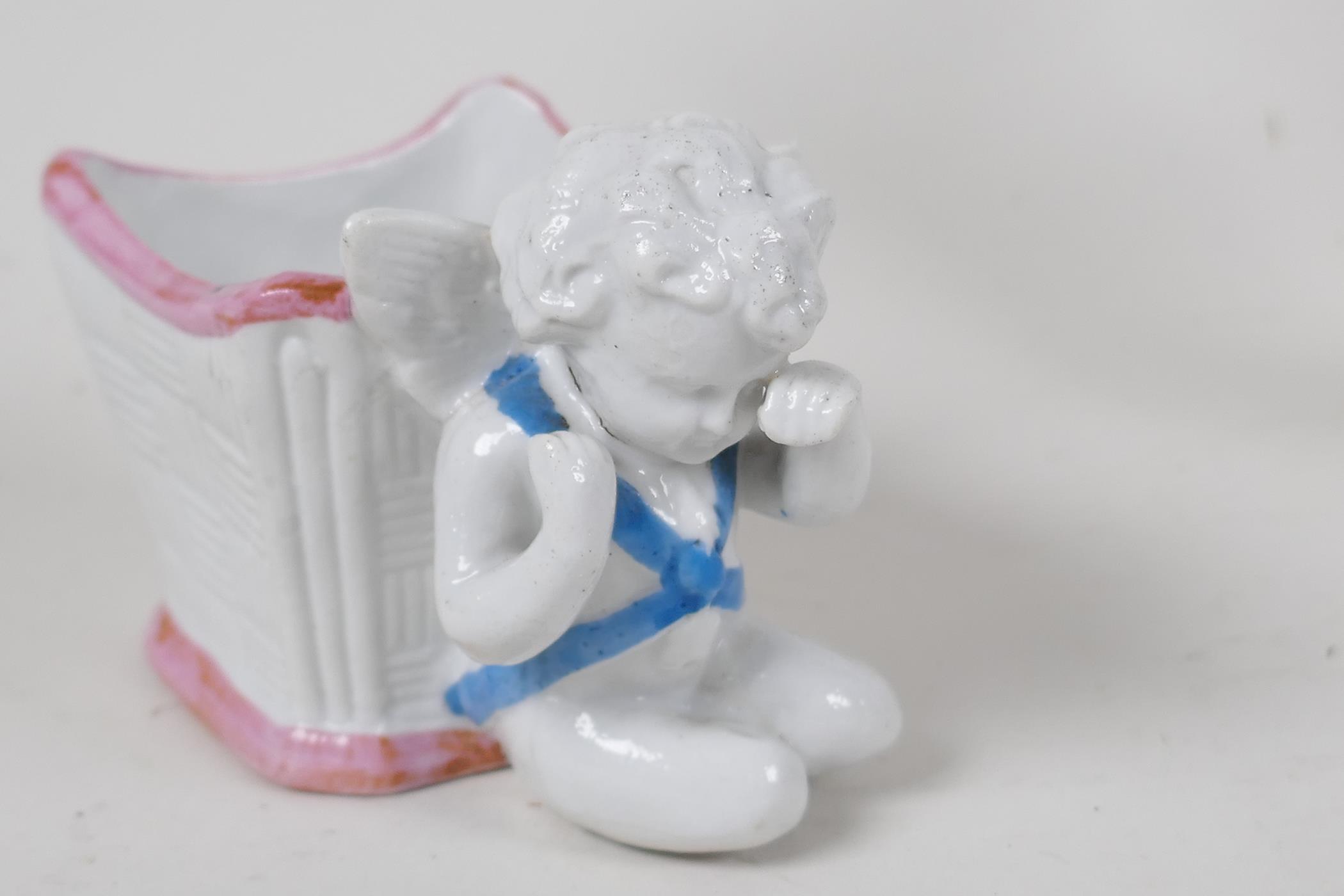 A Continental porcelain figurine of a Dandy holding two puppies, another of a corpulant man in a - Image 4 of 5