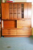 A White & Newton 'Chichester' teak high board, the upper section with bi-fold cupboard doors, and