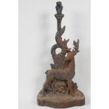 An C19th cast iron door stop, in the form of a stag by a tree