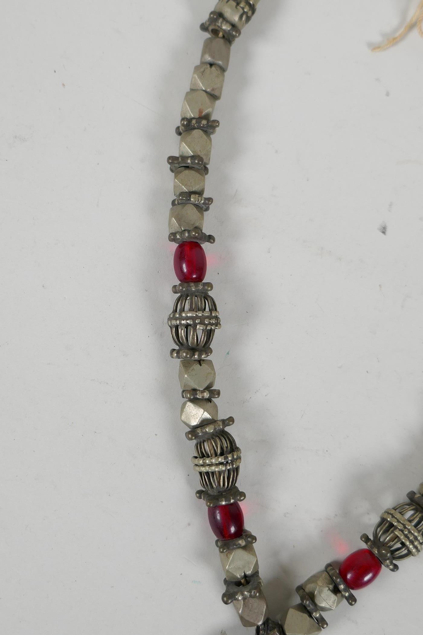 A Turkmen white metal & bead necklace with an Ottoman coin feature pendant, set with stones & bells, - Image 3 of 4