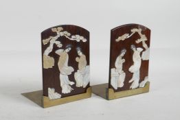 A pair of Chinese brass and hardwood bookends with applied carved Mother of Pearl decoration of