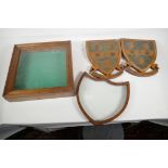 A small table top display case, 13" square, a shield  shaped frame and a pair of inlaid wooden