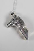 A sterling silver pendant whistle in the form of a horses head, on a 925 silver chain, 2" drop