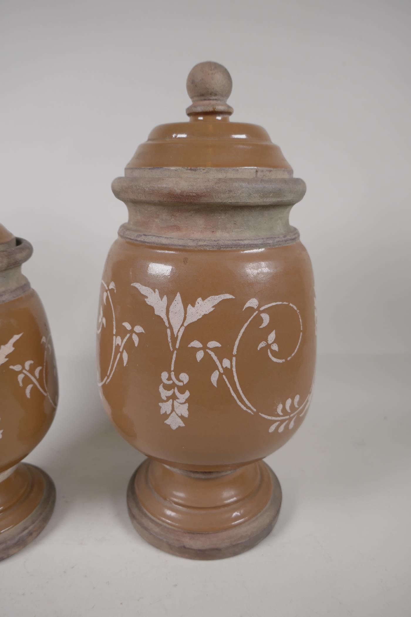 Two French stoneware lidded storage jars on pedestal bases, having painted scrool decoration. - Image 2 of 3