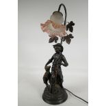 A bronzed composition table lamp cast as a shepherd boy with a lamb, with single glass petal