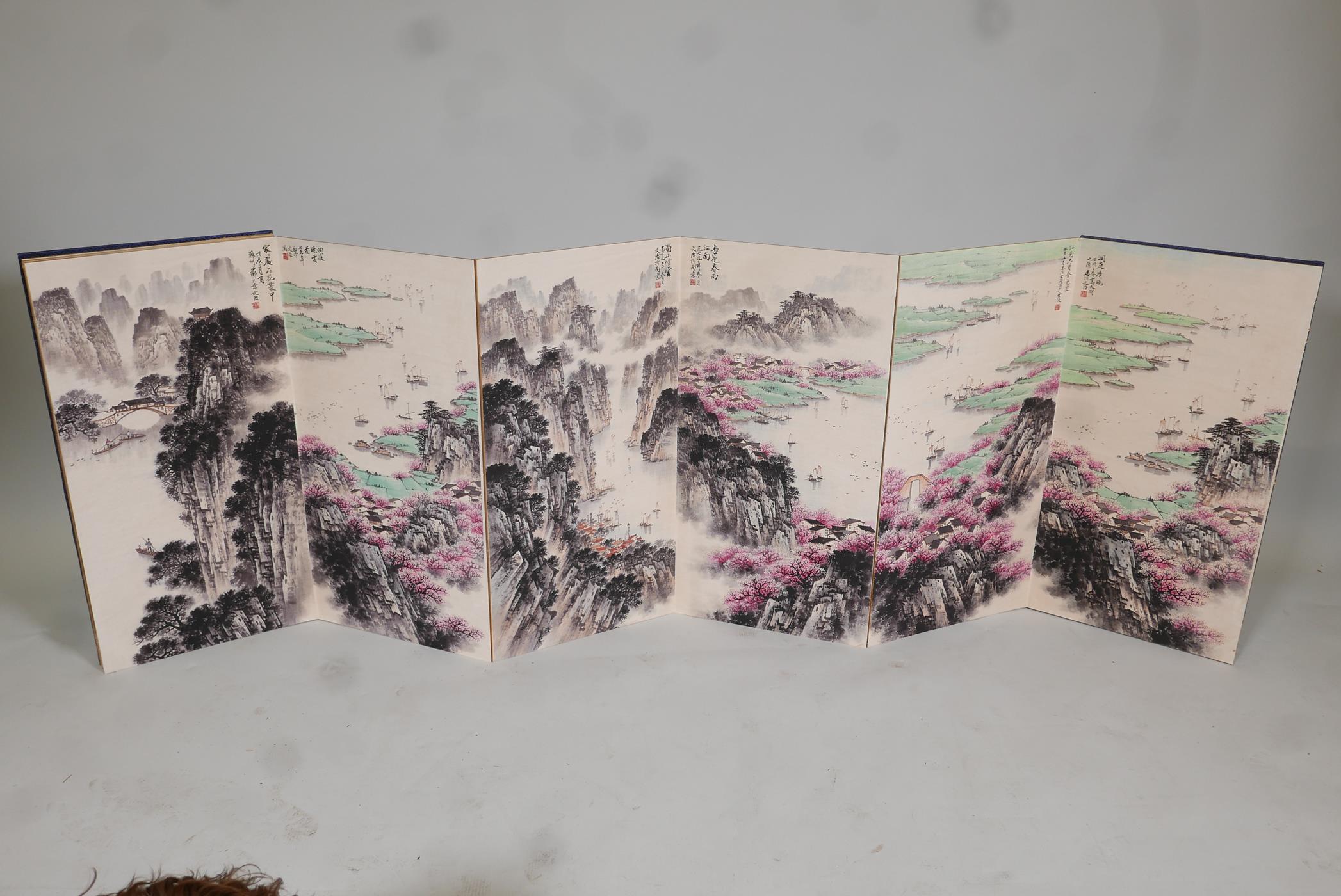A Chinese concertina book, containing ten mountain and riverside landscapes, overpainted prints