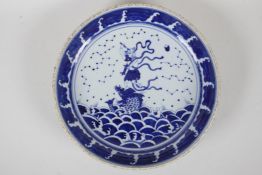 A Chinese Republic period blue and white porcelain dish decorated with Qingao riding a carp, 11½"