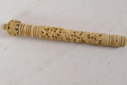 A C19th Canton ivory parasol handle, intricately carved with entwined flowers, 6" long