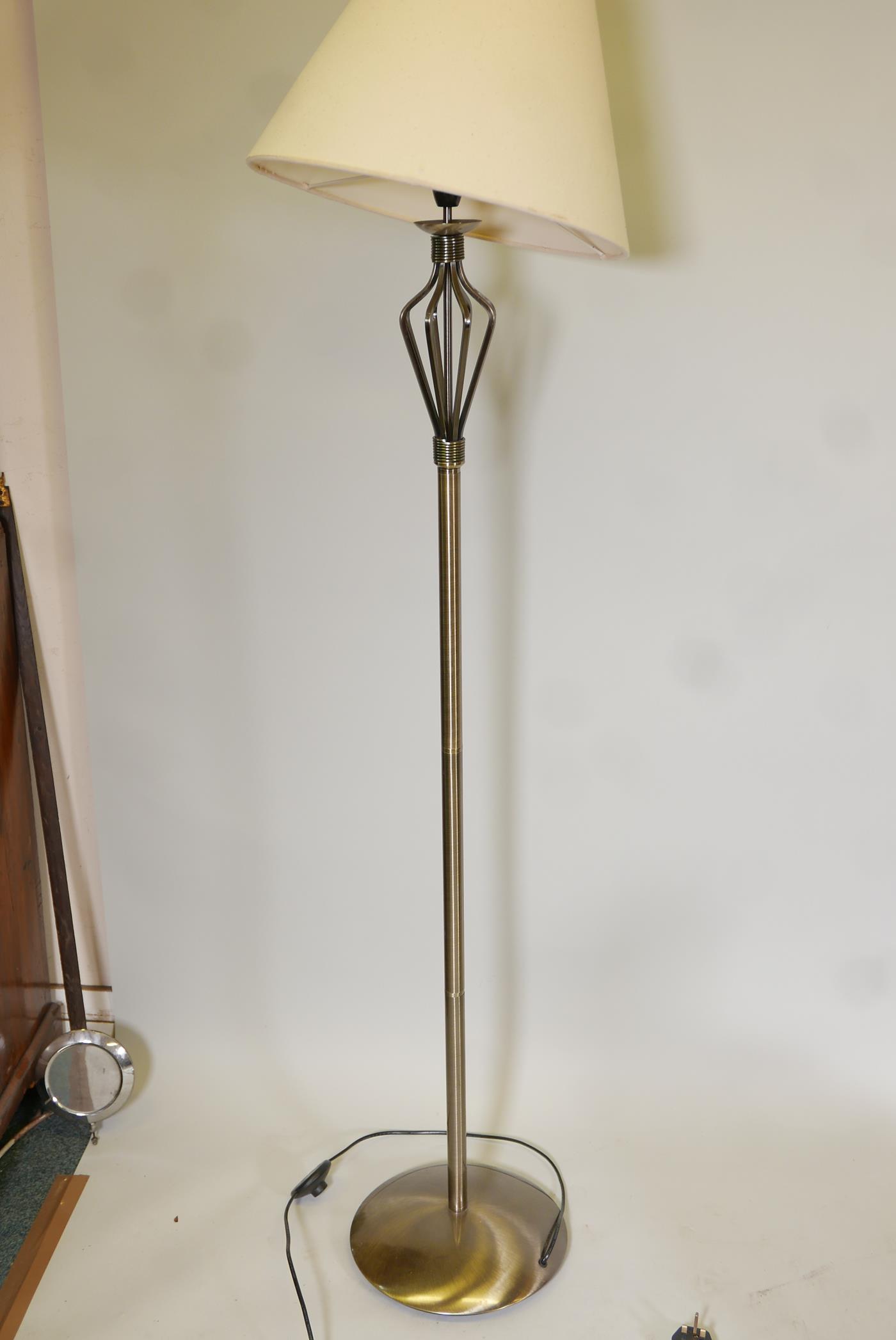 A brushed steel standard lamp. 62" high