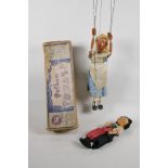 An Alice in Wonderland Pelham Puppet in original box, and a girl's doll with a wire frame, puppet