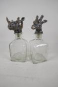 A pair of square section decanterswith plated stoppers, in the form of animal heads. 10" high