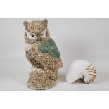 A model of an owl, made from sea shells. Together with a tiger strip nautilus shell