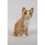 A pottery figure of a cat with glass inset eyes. Indistinctly signed to base. 8½" high