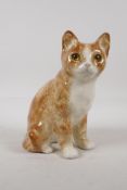 A pottery figure of a cat with glass inset eyes. Indistinctly signed to base. 8½" high