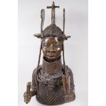 A Benin bronze bust of a figure in elaborate headdress and mail jacket, 22" high