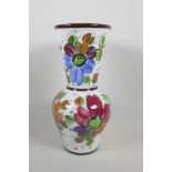 A pottery trumpet vase, hand painted with flowers, 13" high