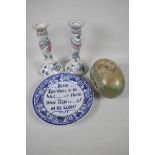 A pair of decorative porcelain candlesticks, 9" high, together with a continental well plate and a