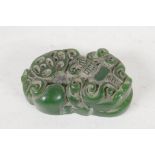 A small Chinese Jade pendant, carved as a mythical creature, 1½" long