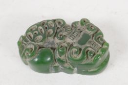 A small Chinese Jade pendant, carved as a mythical creature, 1½" long