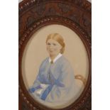 A miniature portrait of a lady, in a good oval carved oak frame. 5¾" x 5" overall